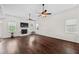Bright living room features dark hardwood floors, a fireplace, and dual ceiling fans at 265 Beckwith Ave, Clayton, NC 27527