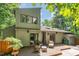 Back of home with large wooden deck, chairs, sliding glass doors and outdoor privacy at 28 Benchmark, Pittsboro, NC 27312