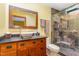 Bathroom featuring stylish vanity, vessel sink, framed mirror, and tiled walk-in shower at 28 Benchmark, Pittsboro, NC 27312