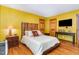 A spacious bedroom with a wood headboard, hardwood floors, and comfortable furnishings at 28 Benchmark, Pittsboro, NC 27312