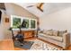 Bright workout room with a high ceiling, ceiling fan, large windows, exercise bike and relaxing couch at 28 Benchmark, Pittsboro, NC 27312
