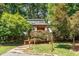 Charming home with stone and gravel pathway, framed by lush greenery and decorative lighting at 28 Benchmark, Pittsboro, NC 27312