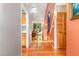 Hallway with hardwood floors that leads to a naturally lit living space, creating a bright atmosphere at 28 Benchmark, Pittsboro, NC 27312