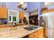 The kitchen has an undermount stainless sink, stainless refrigerator, granite countertop, and open clerestory at 28 Benchmark, Pittsboro, NC 27312