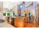 A modern kitchen featuring updated appliances, granite countertops, wood cabinets, and a dining nook at 28 Benchmark, Pittsboro, NC 27312