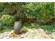 Unique bubbling water feature surrounded by lush greenery in a serene backyard setting at 28 Benchmark, Pittsboro, NC 27312