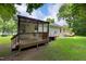 Exterior view of the home with a wooden back porch and a well-maintained yard at 308 E Gilbreath St, Graham, NC 27253