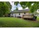 Expansive backyard featuring lush greenery, wooden deck and a well-maintained lawn at 308 E Gilbreath St, Graham, NC 27253