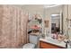 Cozy bathroom featuring a vanity with wood accents and a charming shower curtain at 308 E Gilbreath St, Graham, NC 27253