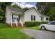 Cozy single-story home featuring a welcoming front porch and well-manicured lawn at 308 E Gilbreath St, Graham, NC 27253