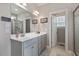 Bright bathroom featuring double sink vanity with framed mirrors and a glass shower at 308 Nashville Dr, Archer Lodge, NC 27527