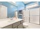 Bright bathroom with tub shower, vanity, and blue walls at 308 Nashville Dr, Archer Lodge, NC 27527
