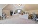 Large bedroom with a pitched ceiling with ceiling fans, carpet flooring and lounge area at 308 Nashville Dr, Archer Lodge, NC 27527