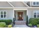 Inviting front door with a 'Welcome' sign and lovely landscaping at 308 Nashville Dr, Archer Lodge, NC 27527