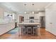 Bright kitchen with island, stainless steel appliances, granite counters, and hardwood floors at 308 Nashville Dr, Archer Lodge, NC 27527