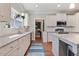 Modern kitchen with white cabinets, granite countertops, and hardwood floors at 308 Nashville Dr, Archer Lodge, NC 27527