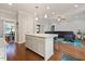 Open concept kitchen featuring granite countertops, stainless steel appliances and hardwood floors at 308 Nashville Dr, Archer Lodge, NC 27527