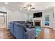 Comfortable living room with hardwood floors, stone fireplace and contemporary furnishings at 308 Nashville Dr, Archer Lodge, NC 27527