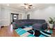 Living room features a large sectional sofa, hardwood floors, and bright, neutral paint at 308 Nashville Dr, Archer Lodge, NC 27527