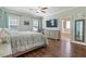 Spacious main bedroom with hardwood flooring, ceiling fan, and ensuite bathroom at 308 Nashville Dr, Archer Lodge, NC 27527