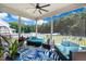 Screened in porch with cozy seating, ceiling fan and view of the backyard at 308 Nashville Dr, Archer Lodge, NC 27527