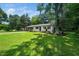 Lovely single-story home with fresh exterior paint, complemented by the large lot, landscaping, and mature trees at 313 13Th St, Butner, NC 27509