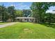 Beautiful home with manicured lawn and landscaping is complemented by mature shade trees in the front yard at 313 13Th St, Butner, NC 27509