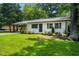 Charming home with freshly painted exterior, lovely landscaping, and a well-manicured front lawn at 313 13Th St, Butner, NC 27509