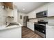 Well-lit kitchen featuring new appliances, ample counter space, and stylish design at 313 13Th St, Butner, NC 27509