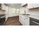 Bright kitchen with white cabinets, stainless steel appliances, and updated countertops for modern living at 313 13Th St, Butner, NC 27509