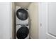 A stacked white washer and dryer set is installed in the laundry area of this home at 313 13Th St, Butner, NC 27509