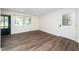 Bright and airy living room with updated flooring, offering a clean and spacious atmosphere at 313 13Th St, Butner, NC 27509