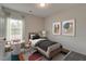Cozy bedroom with playful decor and a charming seating area by the window at 343 Augusta Pond Way # 176, Raleigh, NC 27603