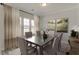 Elegant dining room with large windows, neutral tones, and seating for six at 343 Augusta Pond Way # 176, Raleigh, NC 27603