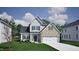 Inviting two-story home featuring a mix of brick and siding, complemented by a well-manicured lawn at 343 Augusta Pond Way # 176, Raleigh, NC 27603