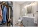 Bathroom with a shower and tub, a large vanity, and a closet with clothes hanging inside at 3622 Colchester St # 17, Durham, NC 27707