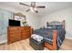Cozy bedroom with a wood frame bed, wooden dresser, ceiling fan and laminate wood floor at 3622 Colchester St # 17, Durham, NC 27707