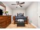 Cozy bedroom with a wood frame bed, wooden dresser, ceiling fan and laminate wood floor at 3622 Colchester St # 17, Durham, NC 27707