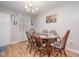 Well-lit dining room with wood floors, round table, and seating for six at 3622 Colchester St # 17, Durham, NC 27707