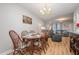 Open dining area with chandelier, wood table, and seamless flow to the living room at 3622 Colchester St # 17, Durham, NC 27707