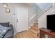 Inviting entryway featuring a white door, wood staircase, and neutral wall paint at 3622 Colchester St # 17, Durham, NC 27707