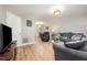 Open living room with wood floors, neutral walls, and comfortable gray furniture at 3622 Colchester St # 17, Durham, NC 27707