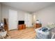 Well-lit living room with a TV, fan, storage, and hardwood floors at 3622 Colchester St # 17, Durham, NC 27707
