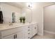 Bathroom vanity featuring double sinks, white cabinets, and a large mirror providing ample space at 405 Bramble Ln, Clayton, NC 27527