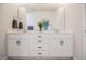 Bathroom vanity featuring double sinks, white cabinets, and a large mirror providing ample space at 405 Bramble Ln, Clayton, NC 27527