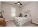 Cozy bedroom with natural light, ceiling fan, and a comfortable bed, creating a relaxing retreat at 405 Bramble Ln, Clayton, NC 27527
