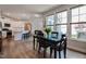 Dining area with floor-to-ceiling windows adjoining a kitchen with stainless steel appliances at 405 Bramble Ln, Clayton, NC 27527