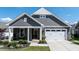 Charming exterior features a stone facade, gray siding, and a well-manicured lawn at 405 Bramble Ln, Clayton, NC 27527