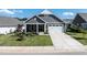 Charming exterior features a stone facade, gray siding, and a well-manicured lawn at 405 Bramble Ln, Clayton, NC 27527