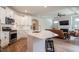 Open-concept kitchen featuring a large island, stainless steel appliances, and seamless flow to living area at 405 Bramble Ln, Clayton, NC 27527